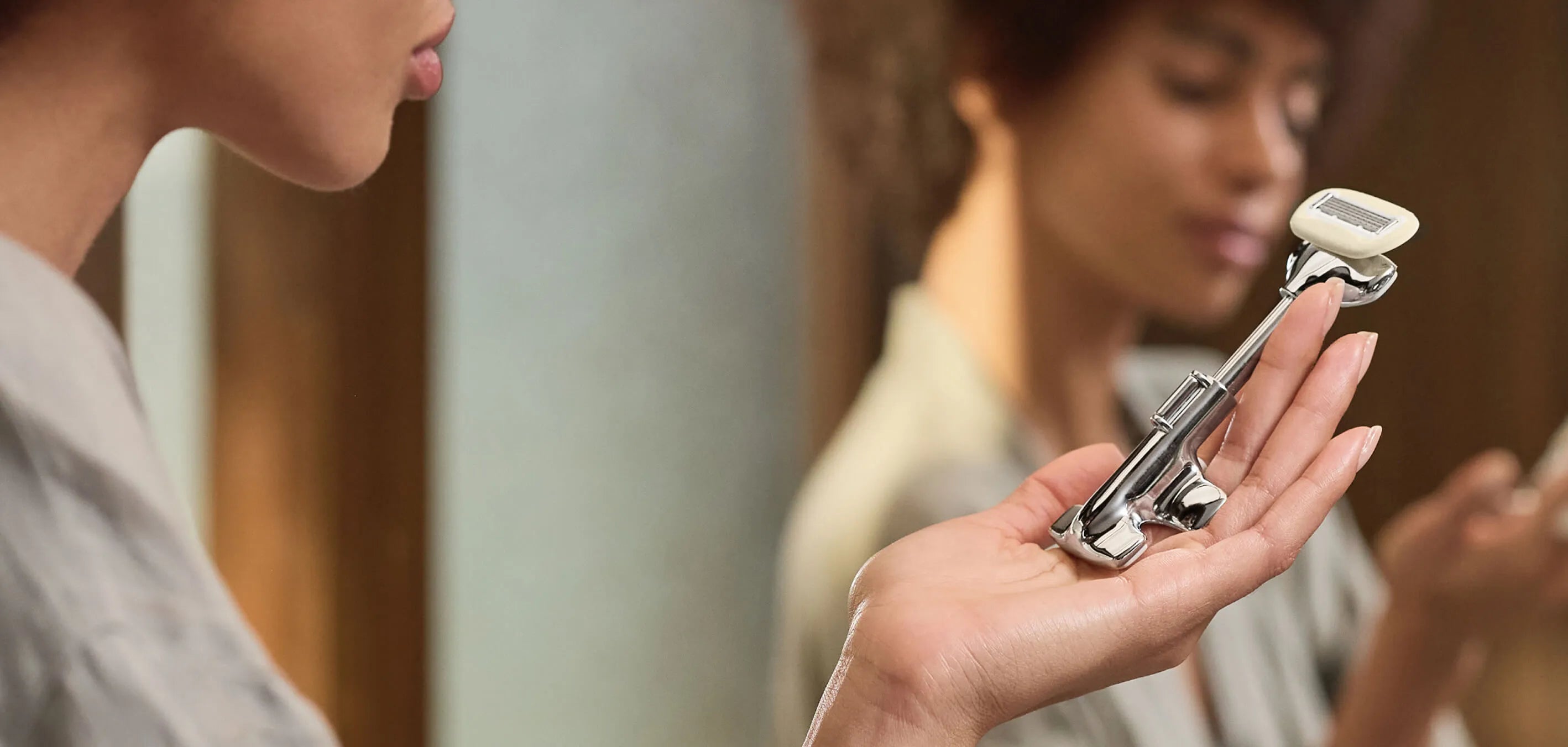 Person holding a razor with a blurred background