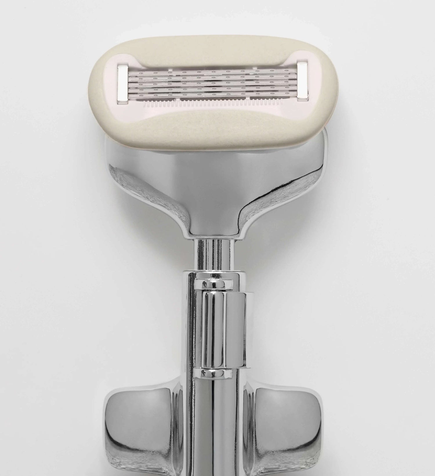 Shaving razor with beige handle on a white background