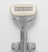 Shaving razor with beige handle on a white background