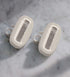 Two razor blade cartridges on a marble countertop
