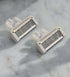 Two white razors with metallic blades on a marble surface