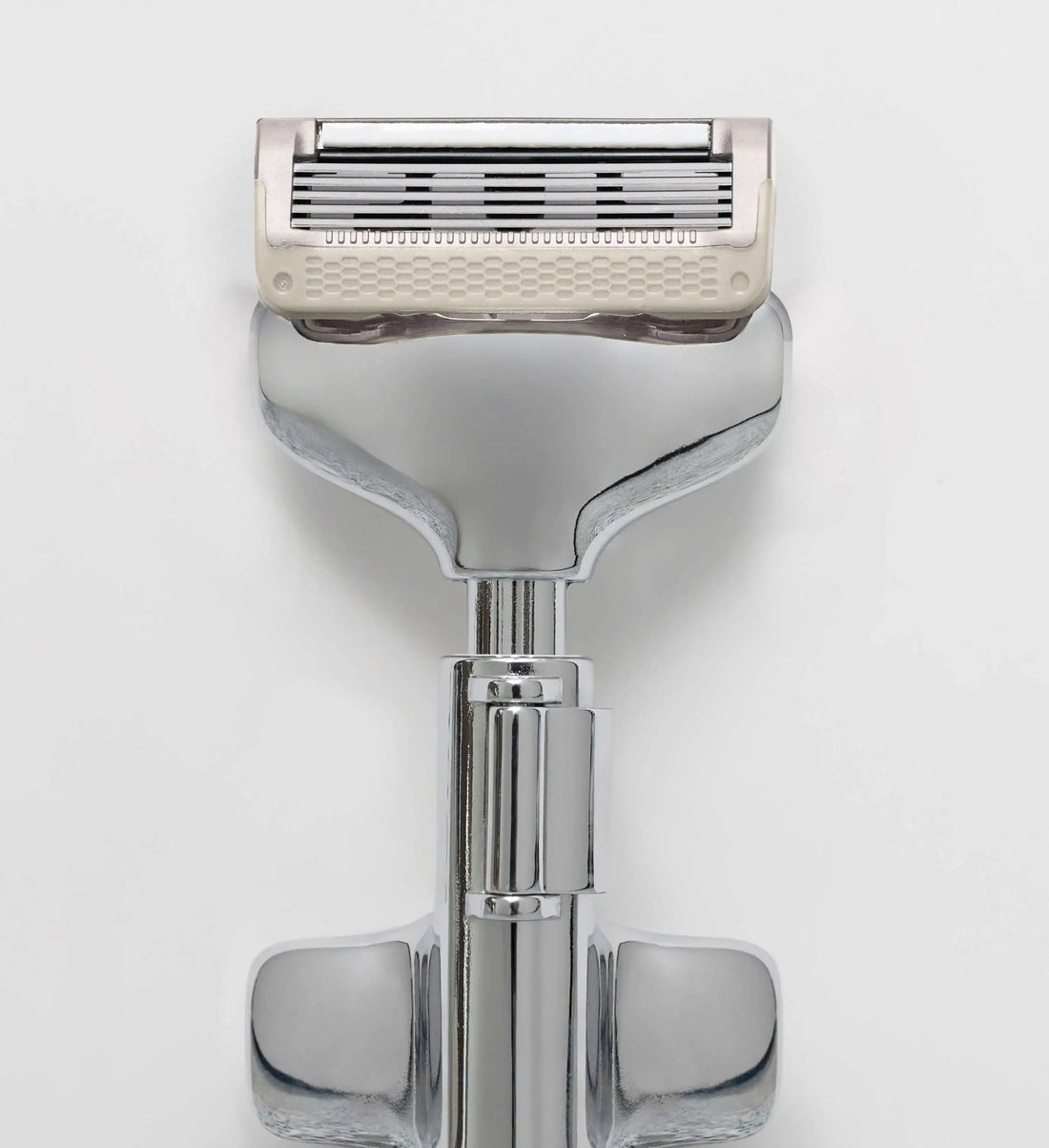 Shaving razor with a white handle on a light gray background