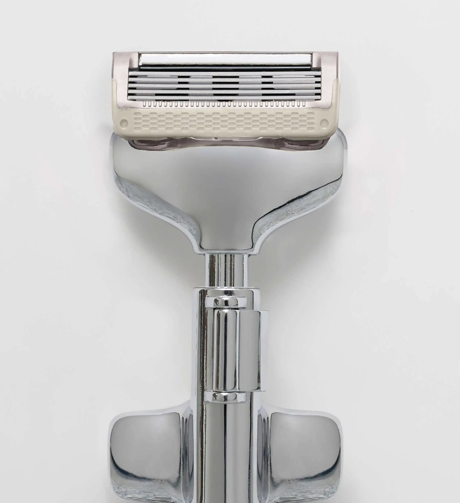 Shaving razor with a white handle on a light gray background