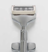 Shaving razor with a white handle on a light gray background