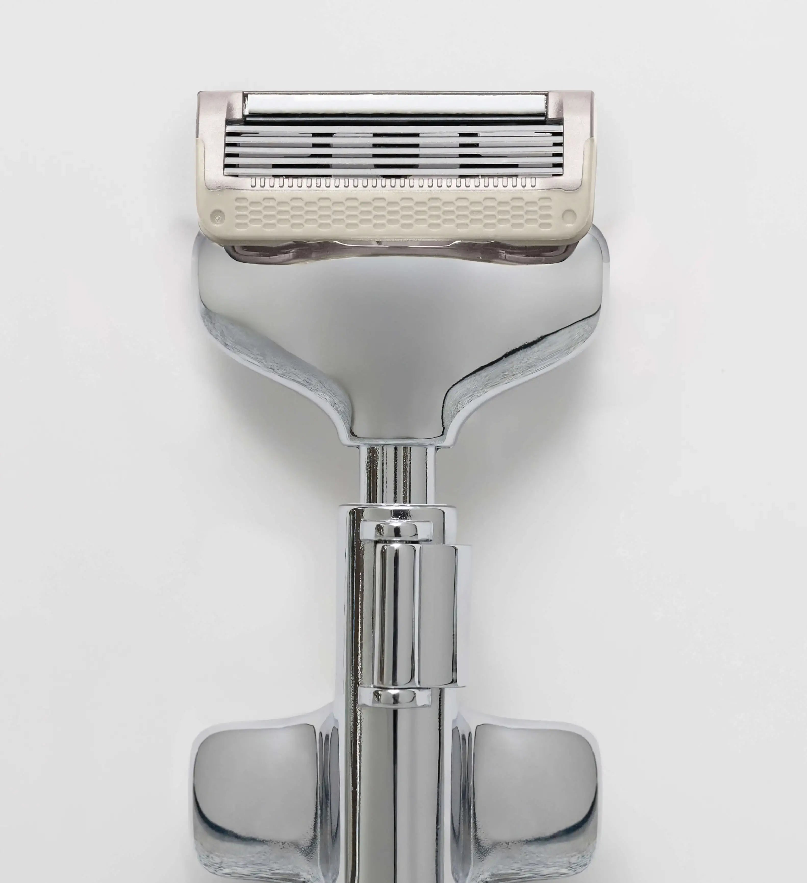 Shaving razor with a white handle on a light gray background