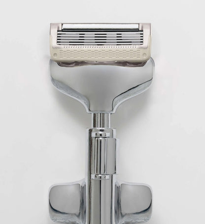 Shaving razor with a white handle on a light gray background